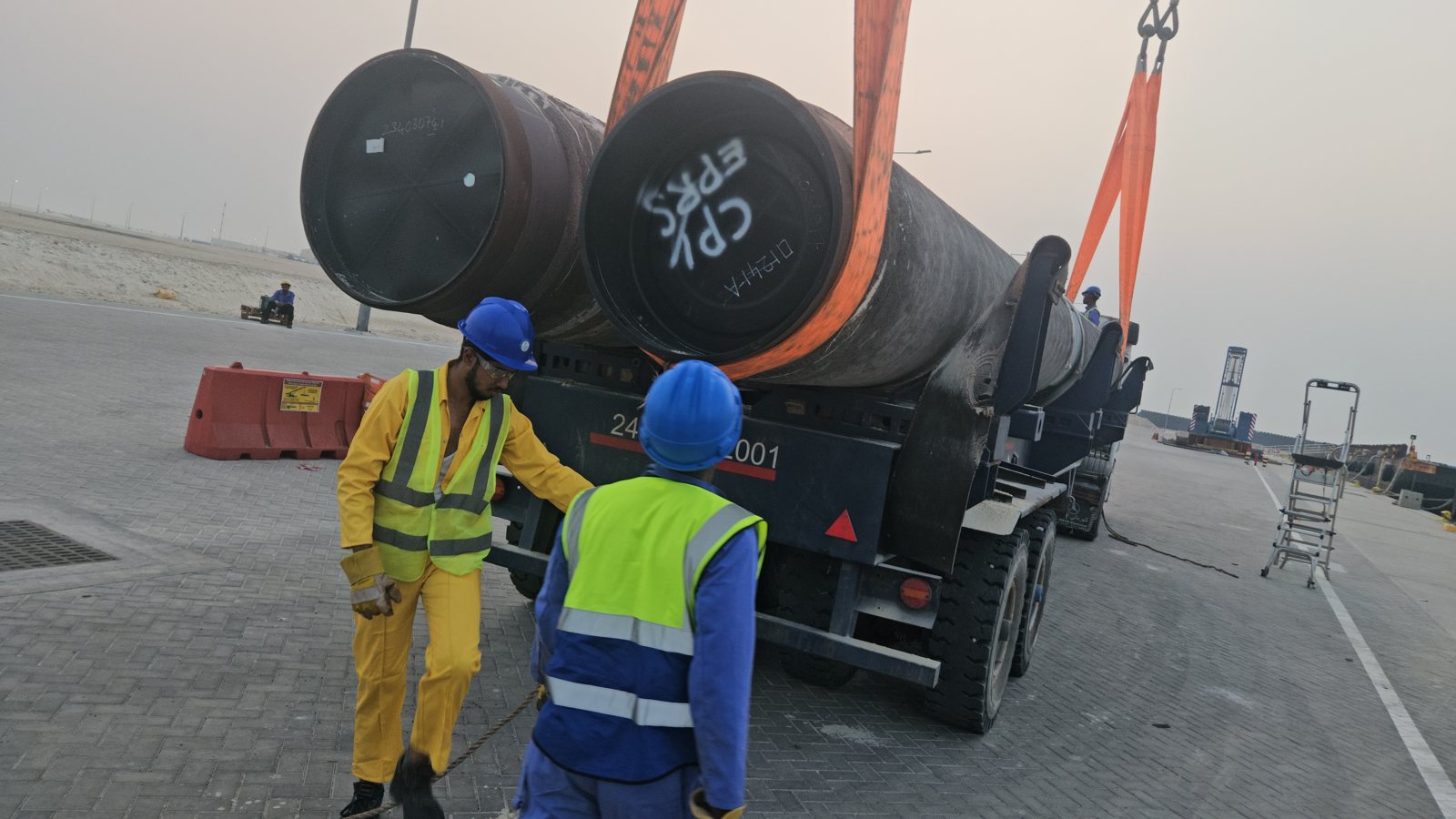 Heavy pipe sections staged for lifting operations on a Qatar project site