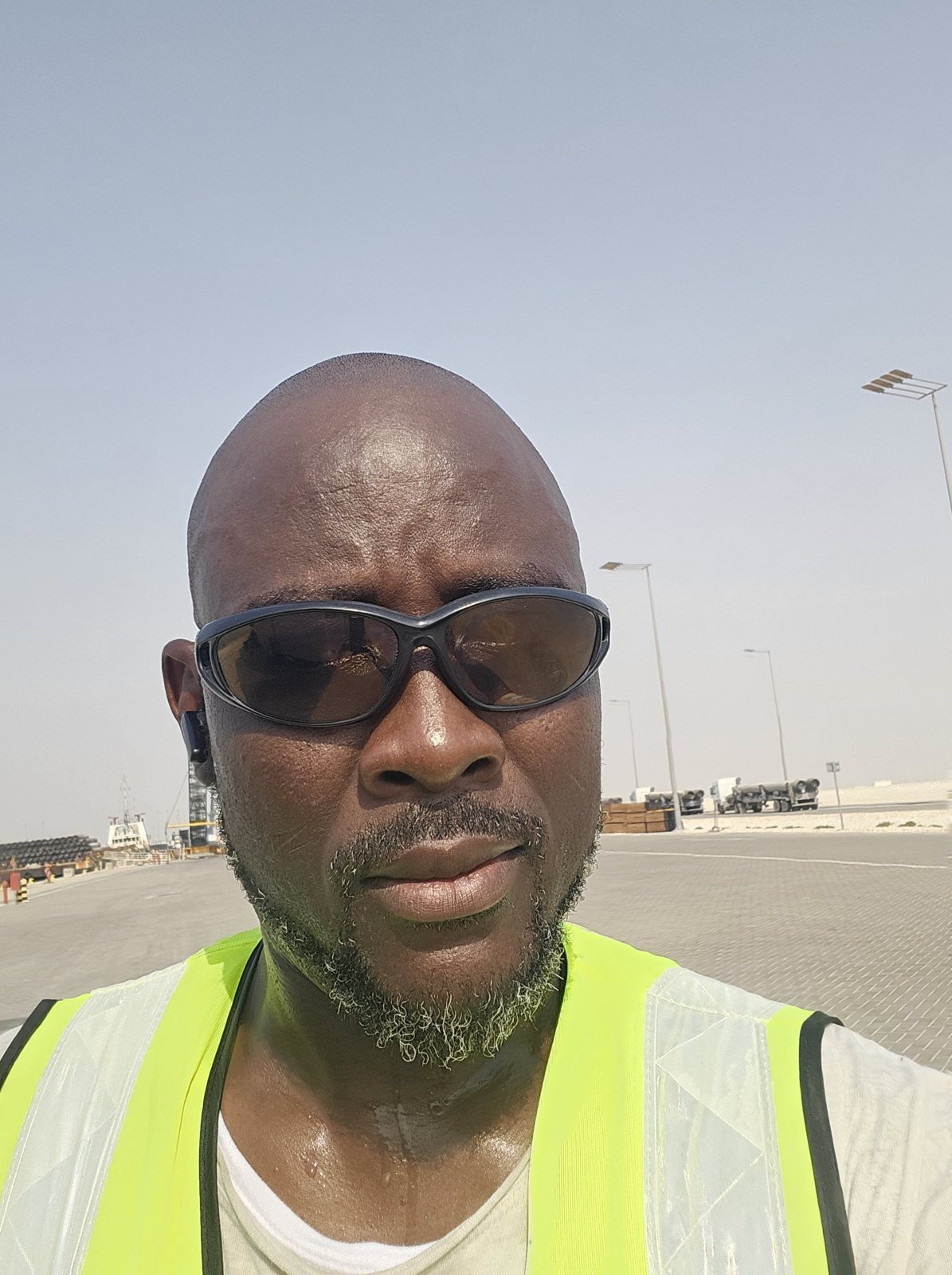 Austin on a construction site in hi-vis safety vest and protective eyewear